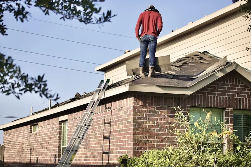 Professional roofer working on a residential roof in Allendale